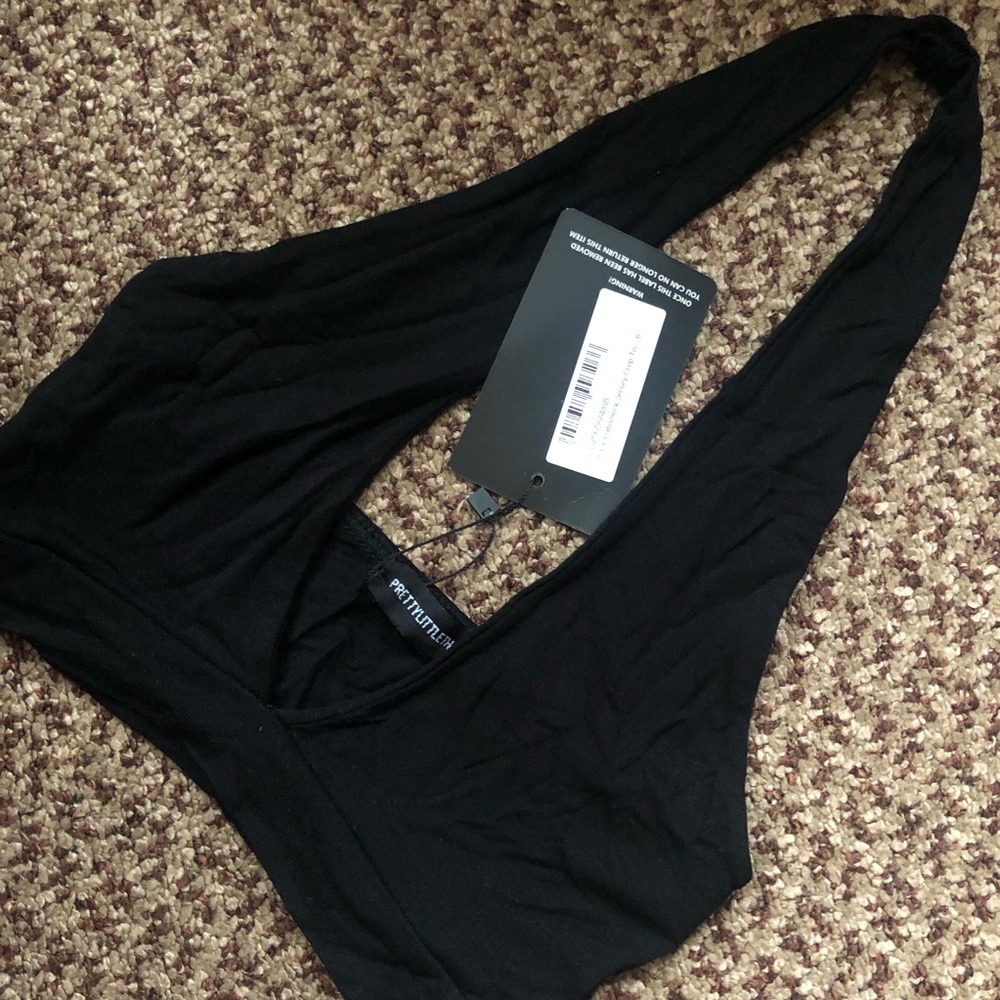 Black PrettyLittleThing halter neck crop top.